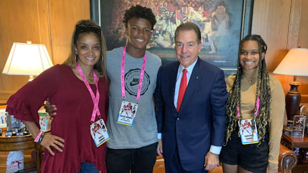 Caleb Downs and his family with Nick Saban.